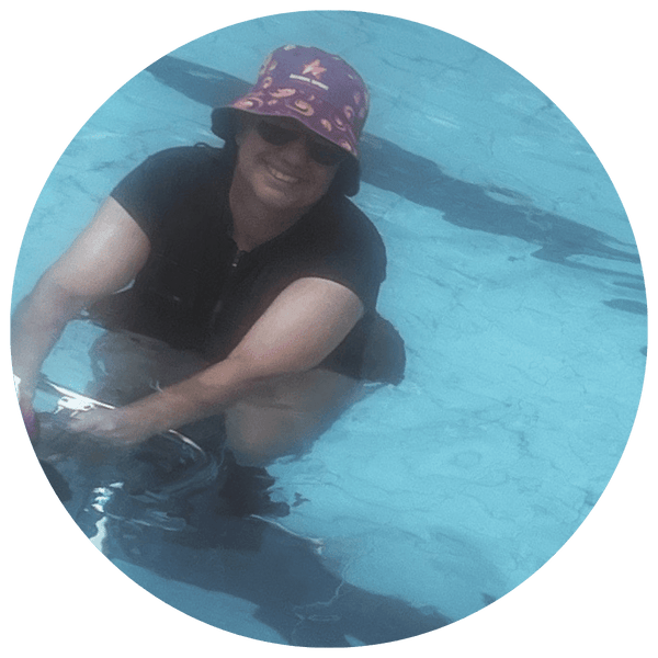 Woman with a balance disorder aqua cycling in pool