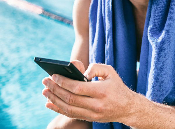 Man Using His Phone Before Workout