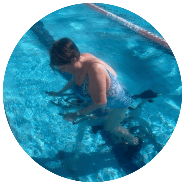 Woman with a knee replacement water cycling in pool