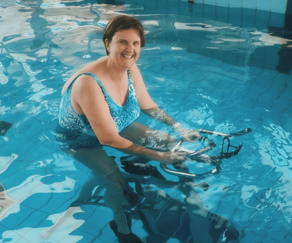 Woman water cycling post a knee replacement